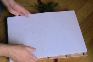 Placing white cardboard sheet for cushioning